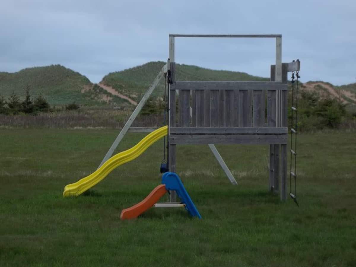 Children's playground set is visible from the cottage. Loads of space for safe, playful fun!